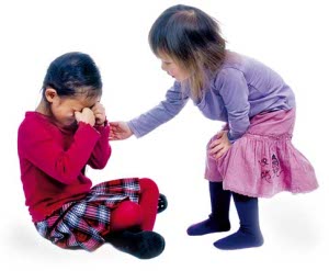 Younger sister offers comfort to her big sister after a fall.
